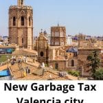 Valencia city rooftops and historic towers under a clear blue sky, with bold white text saying 'New Garbage Tax Valencia city' across the bottom.